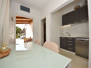 Enjoy cooking in this well-equipped kitchen with an oven, range hood, and dishwasher.