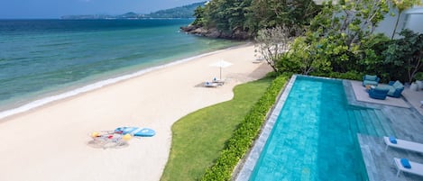 On the beach, white sand, sun-loungers, beach umbrellas