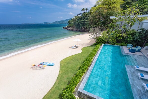 On the beach, white sand, sun-loungers, beach umbrellas