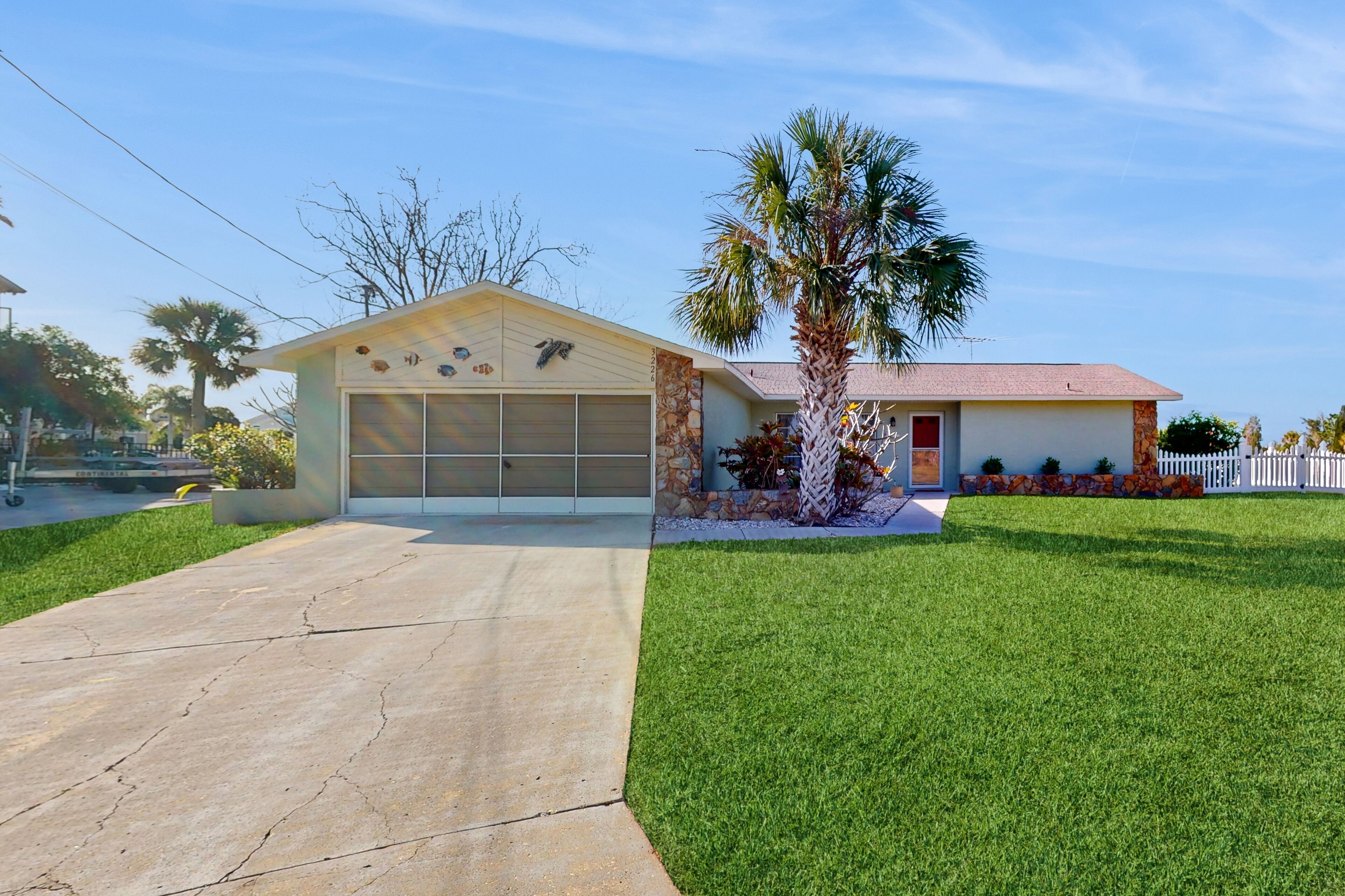 Perfectly located waterside home with dock, grill, screened-in patio, W/D, & AC