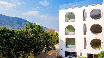 Set amidst lush greenery, this building offers a serene escape with its clean lines and circular windows.