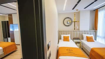 Habitación de hotel con dos camas, un espejo grande y un diseño moderno.