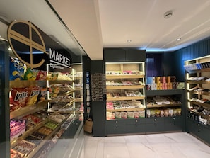 A store with shelves stocked with snacks, chocolates, and other items.
