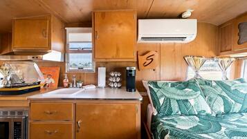 Fridge, microwave, coffee/tea maker, cookware/dishes/utensils