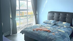 A bedroom with a large bed, a window with curtains, and a view of the outside. - Capital O 90949 Pelangi Beach Resort Mersing (Langkawi)