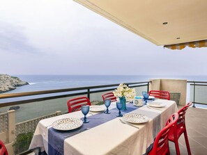 A table set for dining with a view of the sea.