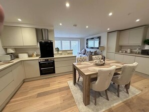 Microwave, oven, dishwasher, dining tables