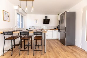 Enjoy cooking in this well-equipped kitchen with a central island and bar stools.