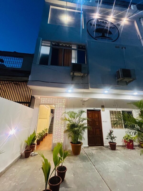 A two-story building with a balcony, potted plants, and a decorative entrance. - GREEN SAPPHIRE INN - BHOPAL (Bhopal)