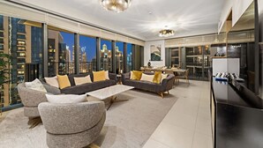 A modern living room with a sofa set, a dining area, and a kitchen. - WORLD CLASS | 2BR | Downtown View (Downtown)