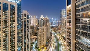 A high-rise building with the name 'EMAAR' prominently displayed on the facade. - WORLD CLASS | 2BR | Downtown View (Downtown)