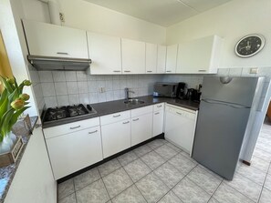 Fridge, stovetop, dishwasher, coffee/tea maker