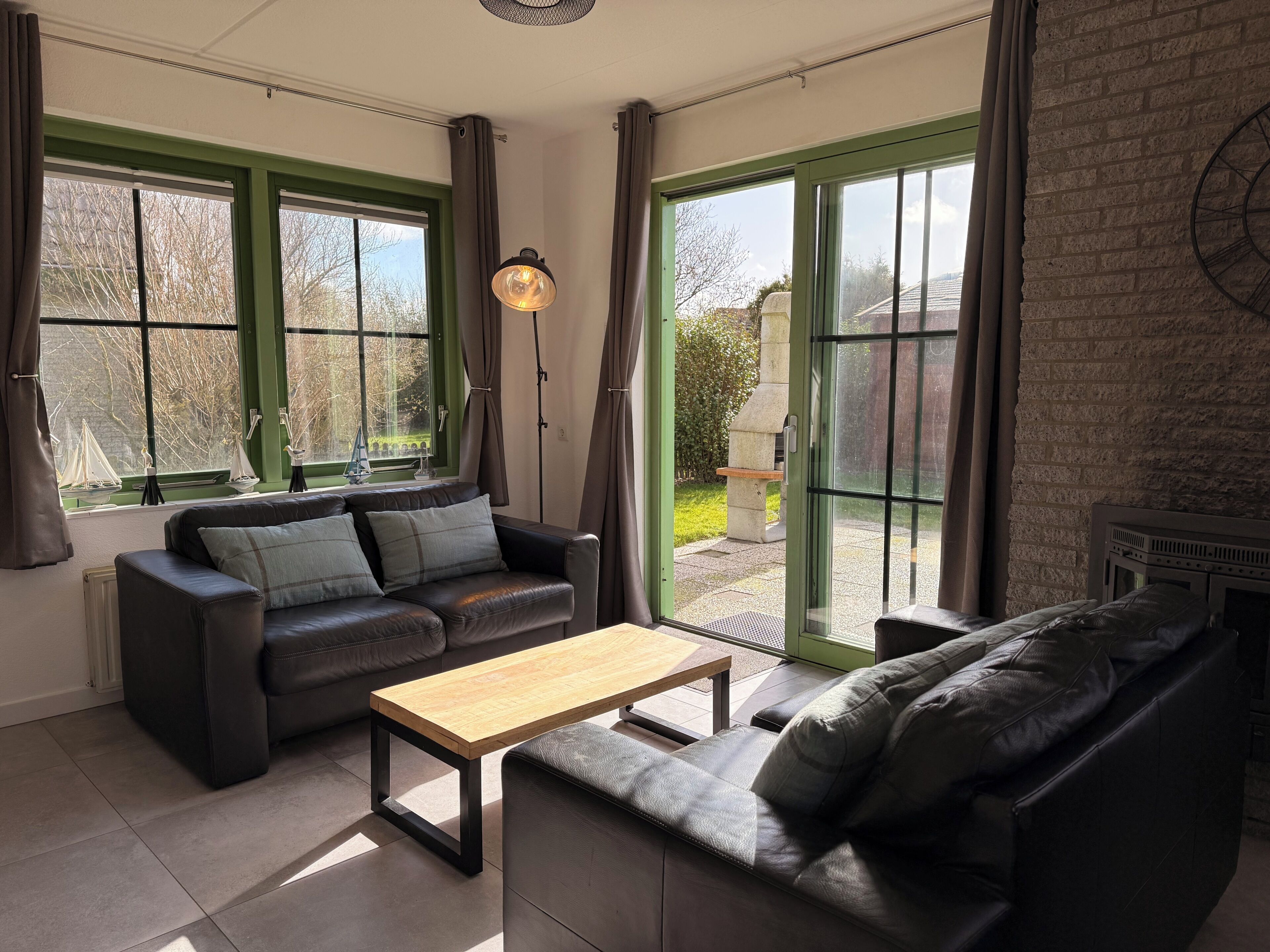 A modern living room with a sofa, a coffee table, and a fireplace.