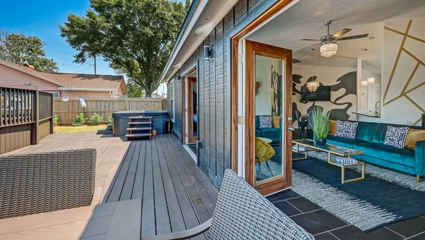 A modern outdoor deck with a wooden bench, a small table, and a sofa. - NAS Jax Pool Hot-tub Gameroom Message for Spring (Jacksonville)