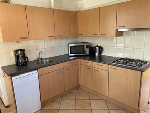 Fridge, stovetop, dishwasher, coffee/tea maker