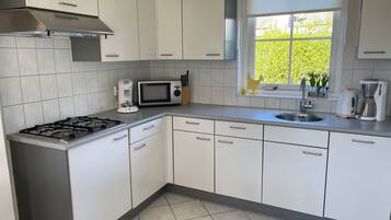 Fridge, stovetop, dishwasher, coffee/tea maker