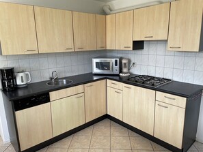 Fridge, stovetop, dishwasher, coffee/tea maker