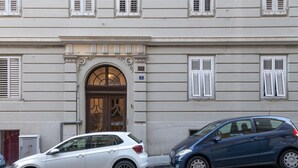 A building with a classic architectural style, featuring a prominent arched entrance and a number '2' sign above the door. - Palladio due - spacious 3 bedrooms (Trieste)
