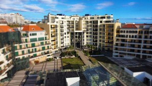 A multi-story residential building with balconies and a central courtyard. - Sunset Bay by LovelyStay (Funchal)