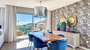 Enjoy meals in this stylish dining area with a large window offering a view of the city.
