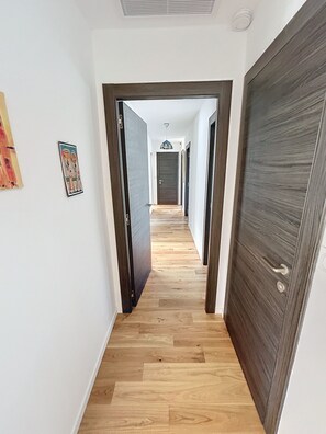 Stylish hallway with a door leading to a space.
