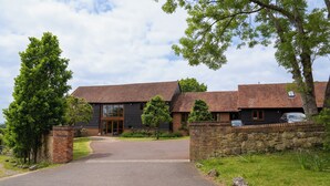 A large, modern building with a brick facade and a stone entrance wall.