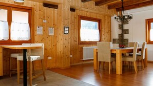 A wooden interior with a dining table and chairs, a radiator, and a chandelier. - Stunning private villa for 4 people with WIFI and TV (Ovaro)