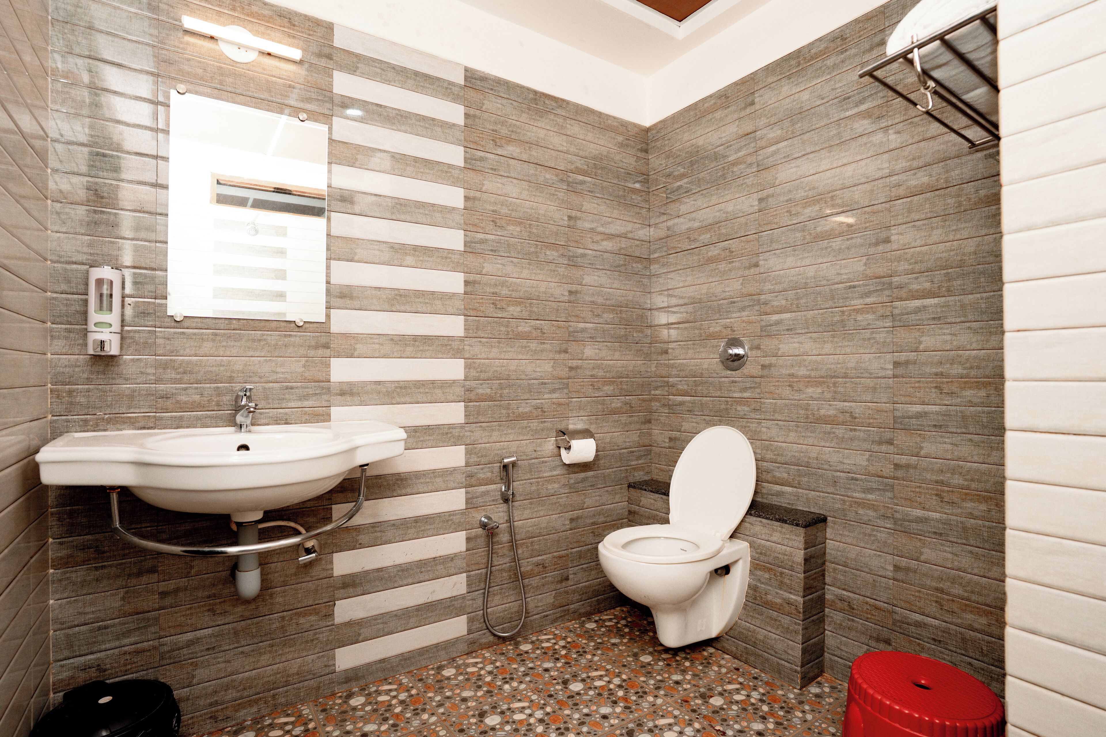 A bathroom with a sink, toilet, and shower.