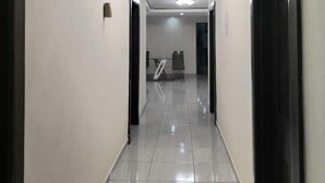 A corridor with a tiled floor, recessed ceiling lights, and doors on both sides. - DBright Guest Lodge (Pretoria)