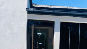 A building entrance with a glass door, a tiled staircase, and a clear sky. - DBright Guest Lodge (Pretoria)