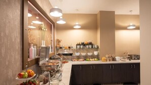 A buffet setup with various food items and beverages, including fruits, cereals, and dairy products. - HOTEL AKROPOL (Katerini)