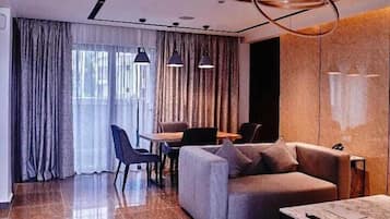 Premium Apartment | Living area | 65-inch Smart TV with cable channels, Netflix, streaming services