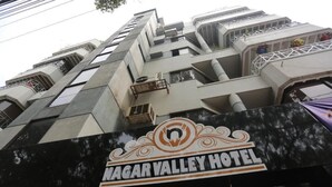 The exterior of Nagar Valley Hotel with a prominent sign, multiple balconies, and a modern architectural design. - Nagar Valley Hotel Ltd. (Dhaka)