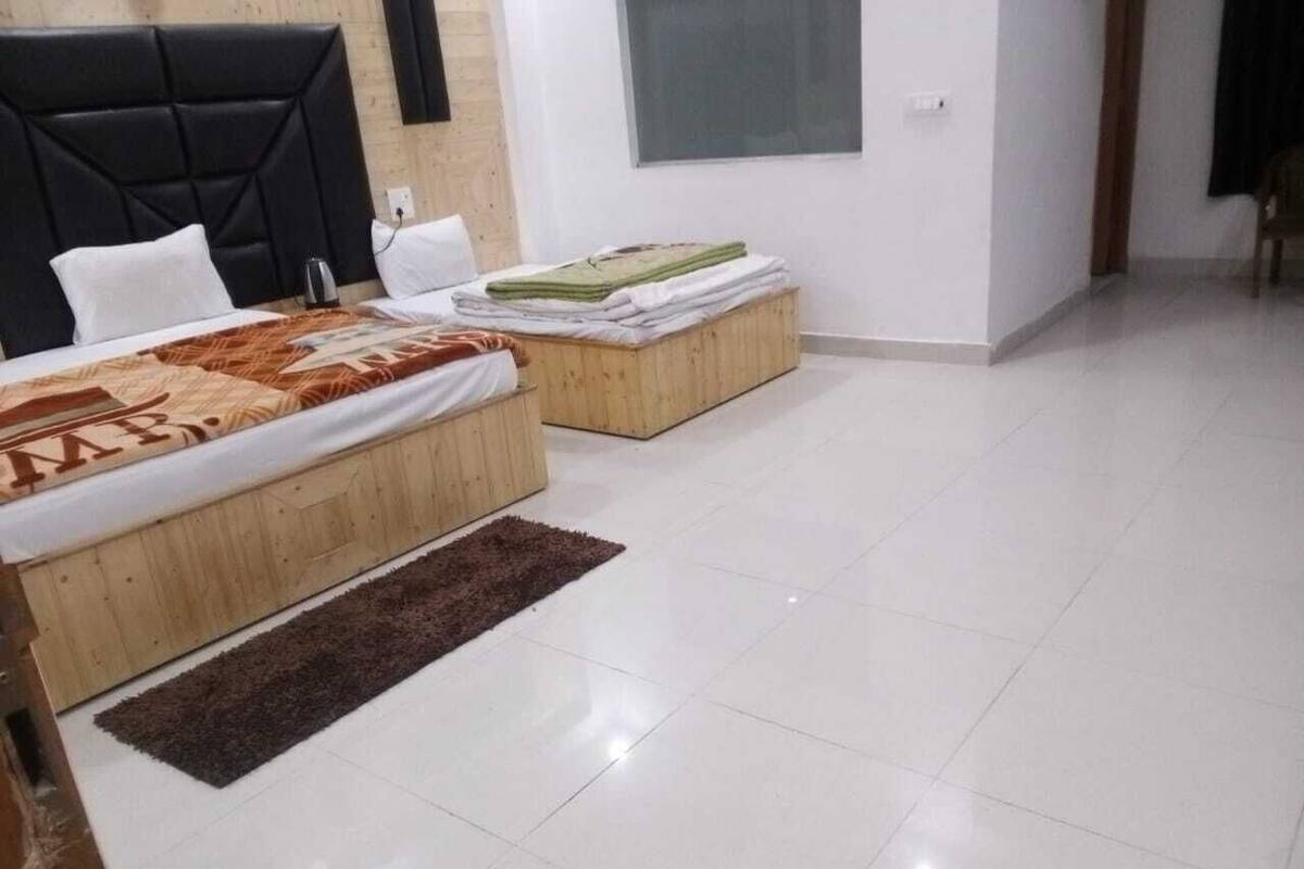 Un dormitorio con una cama, un banco de madera y una alfombra.