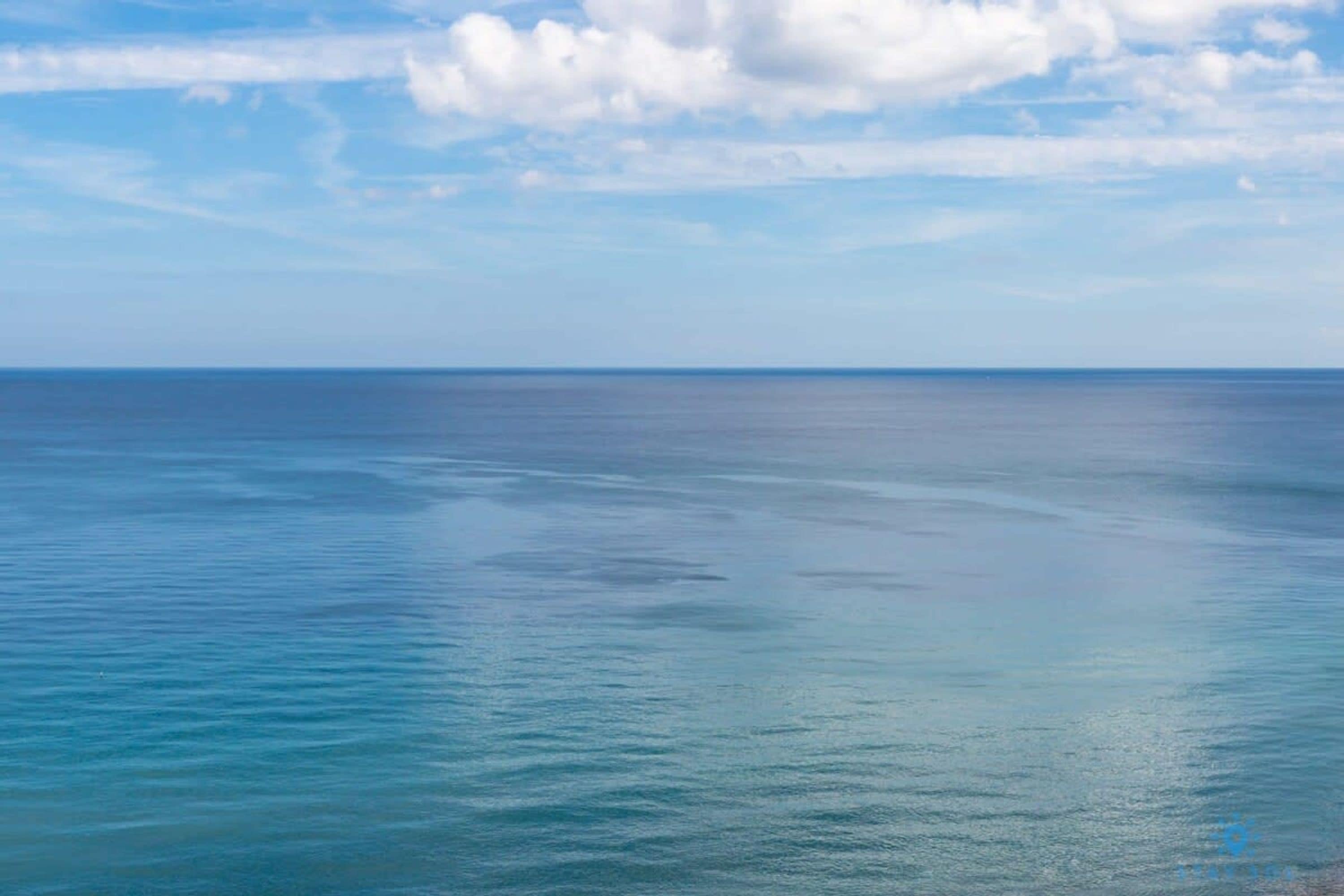 A calm sea under a clear sky.