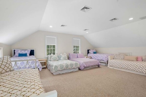 A bedroom with two beds, a window, and a ceiling fan. - The Ultimate Cape Cod luxury home. Dock, pool, hot tub and views! RPMS104 (Osterville)