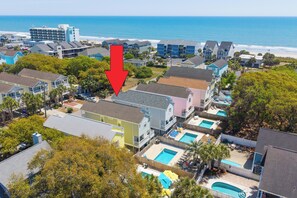 A coastal residential area with houses, a swimming pool, and a view of the ocean. - Walk to the Beach 5 BR Beach House with a Private Pool! Catching R.A.E.S (Surfside Beach)