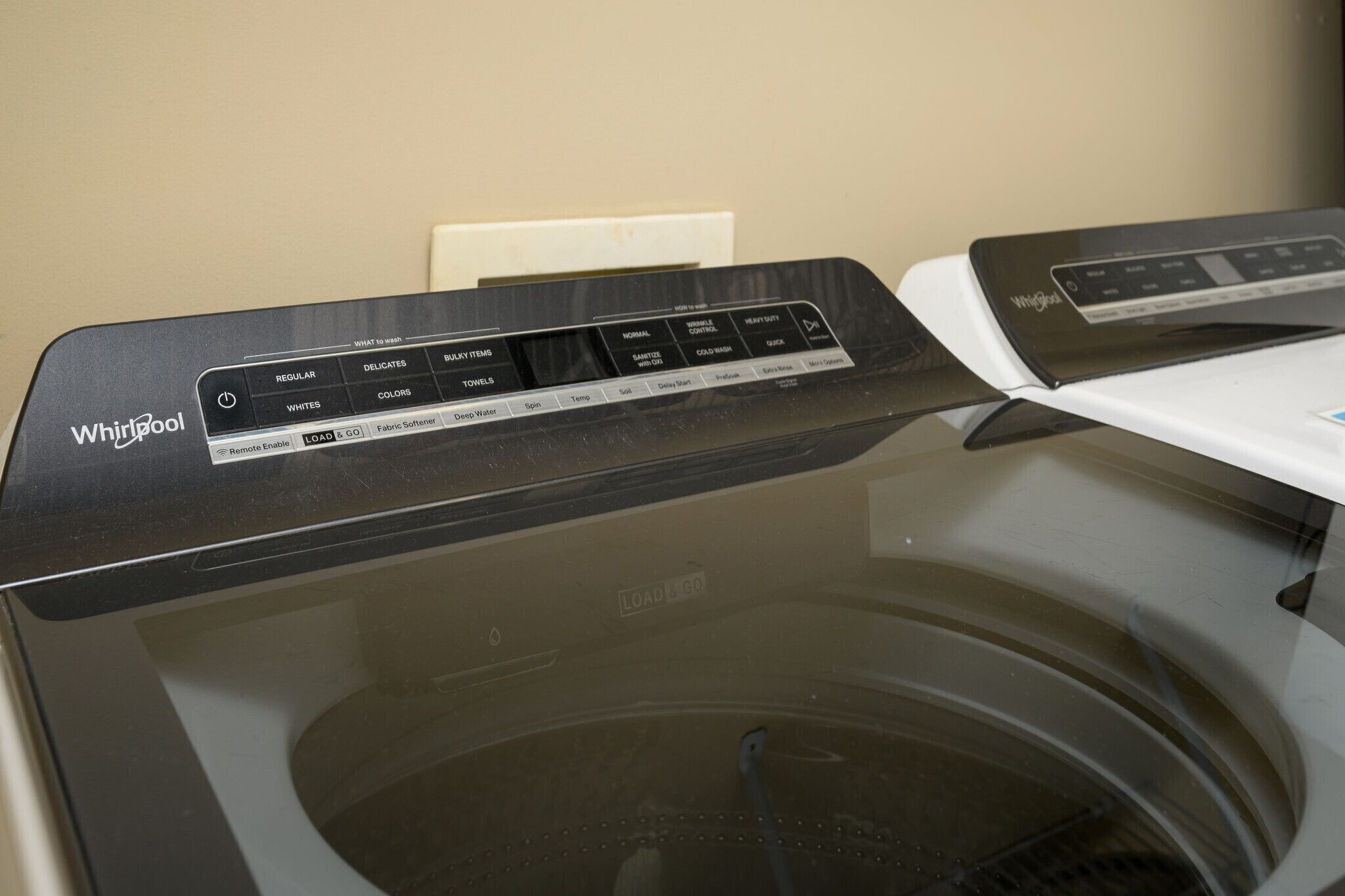 A Whirlpool washing machine with a control panel displaying various settings.