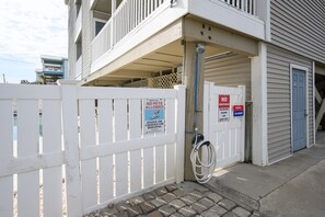 A gated building with a pool, a sign prohibiting pets, and a closed pool sign.