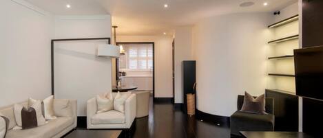A modern living room with a sofa set, a coffee table, and a TV stand.