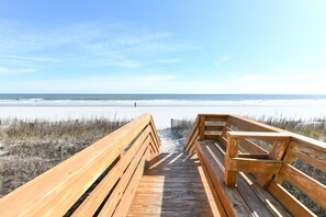 Walk along the boardwalk to the pristine beach with a clear ocean view.