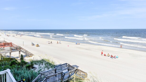 A beach with a wooden boardwalk leading to the water, sandy beach, and ocean waves. - Oceanfront 1 BR Condo with a Shared Pool! South Shores II 201 (Surfside Beach)