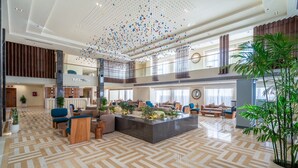 A spacious lobby with a reception desk, seating areas, and a decorative ceiling feature. - Al Masa Hotel El Sokhna (Ataqah)