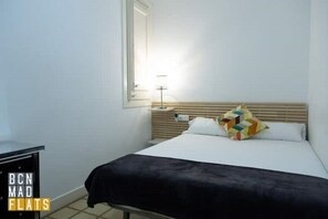 Simple, functional room with a single bed, bedside table, and nightstand.