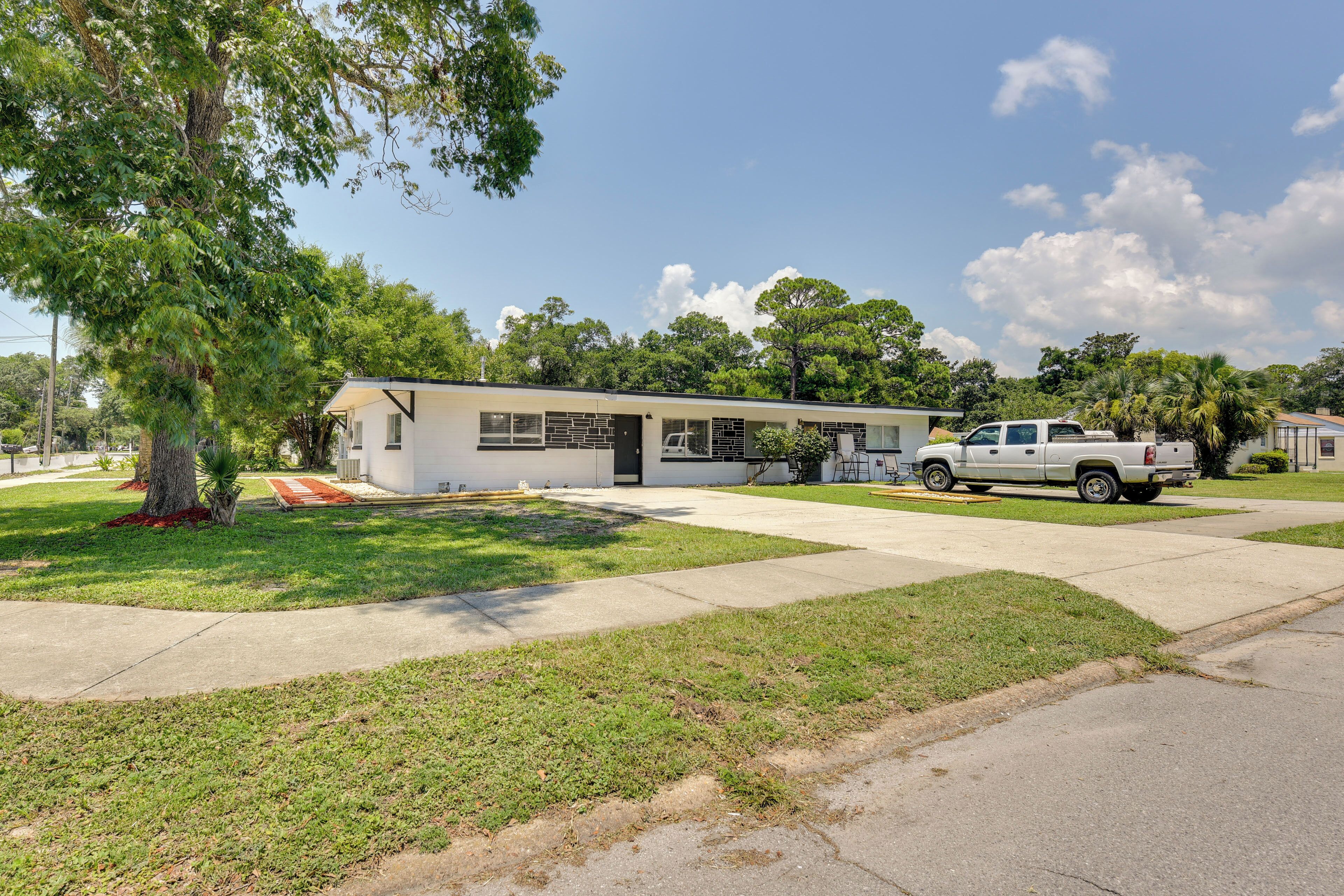 A modern single-story house with a garage, a driveway, and a lawn.