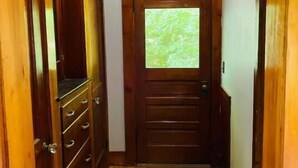 A wooden hallway with a door leading to a room. - Sweet comfy cottage on Small Point Road (Phippsburg)