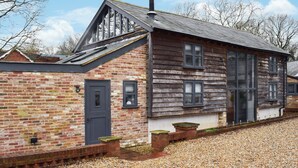 A brick building with a sloped roof and a chimney. - UK46591 - Polecat Barn (Plumpton Green, near Lewes)