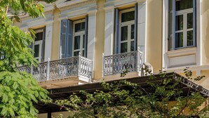 A multi-story building with balconies, large windows, and a classic architectural style. - Soho Athinas 60 (Athens)