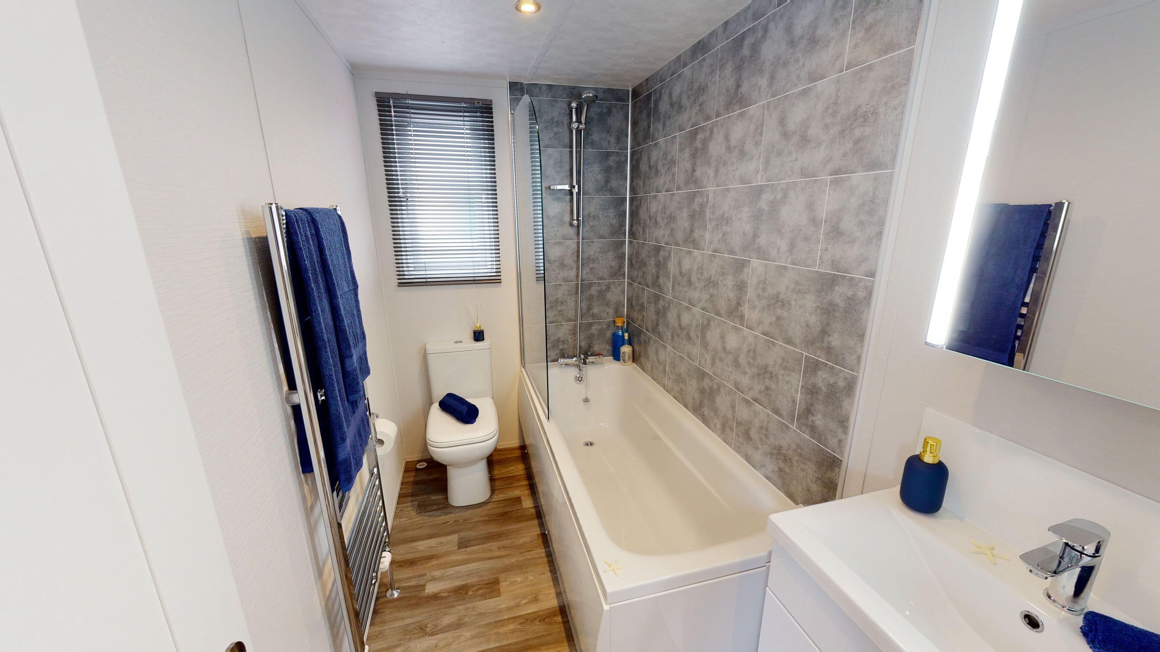 A bathroom with a bathtub, toilet, and a shower.