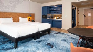 A hotel room with a bed, a desk, a chair, and a kitchenette. - ibis Styles Burton Upon Trent - Hotel & Suites (Burton on Trent)